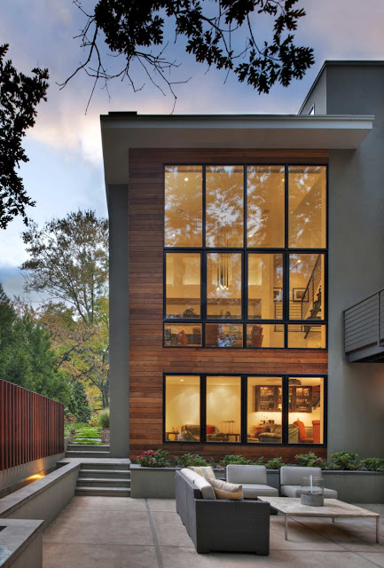 Dark Brown Wall Made from Wooden Material and Bright Soft Cream Lighting Inside the House