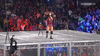 Ryback goes on top of the cage and carries CM Punk to perform his finisher