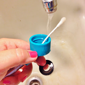 Washing the water bottle spout and gasket with a cotton swab and castille soap.  Nail Polish is Orly in Berry Blast.