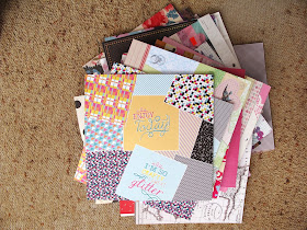 Pile of scrapbooking paper pads on the floor.