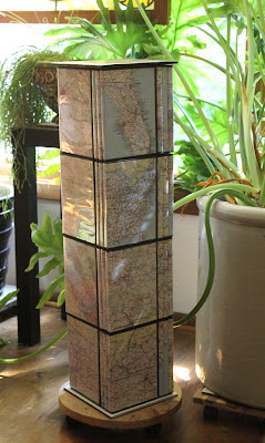 plant stand made from map covered dvd cases