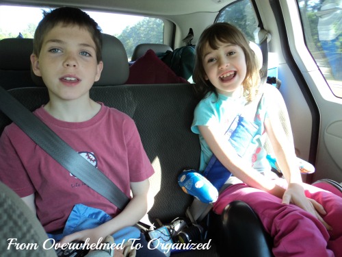 From Overwhelmed to Organized. Boy and girl sitting in back seat of a car.