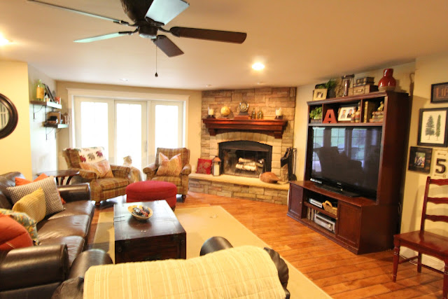 family room with brown leather sofas and corner stone fireplace - www.goldenboysandme.com