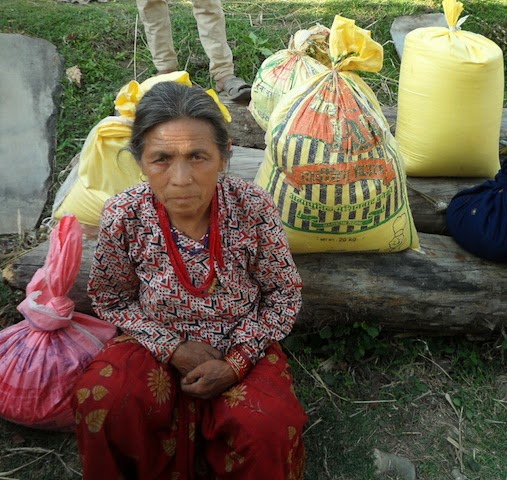 A woman from Bhaktapur receives relief supplies