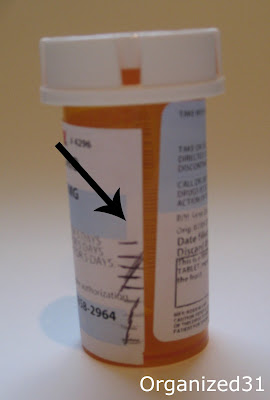 an arrow pointing to marks made on a prescription medicine bottle
