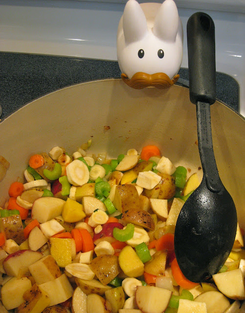 labbit addes veggies to the pot