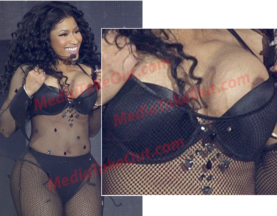 Nicki Minaj's boobs pops out on stage.