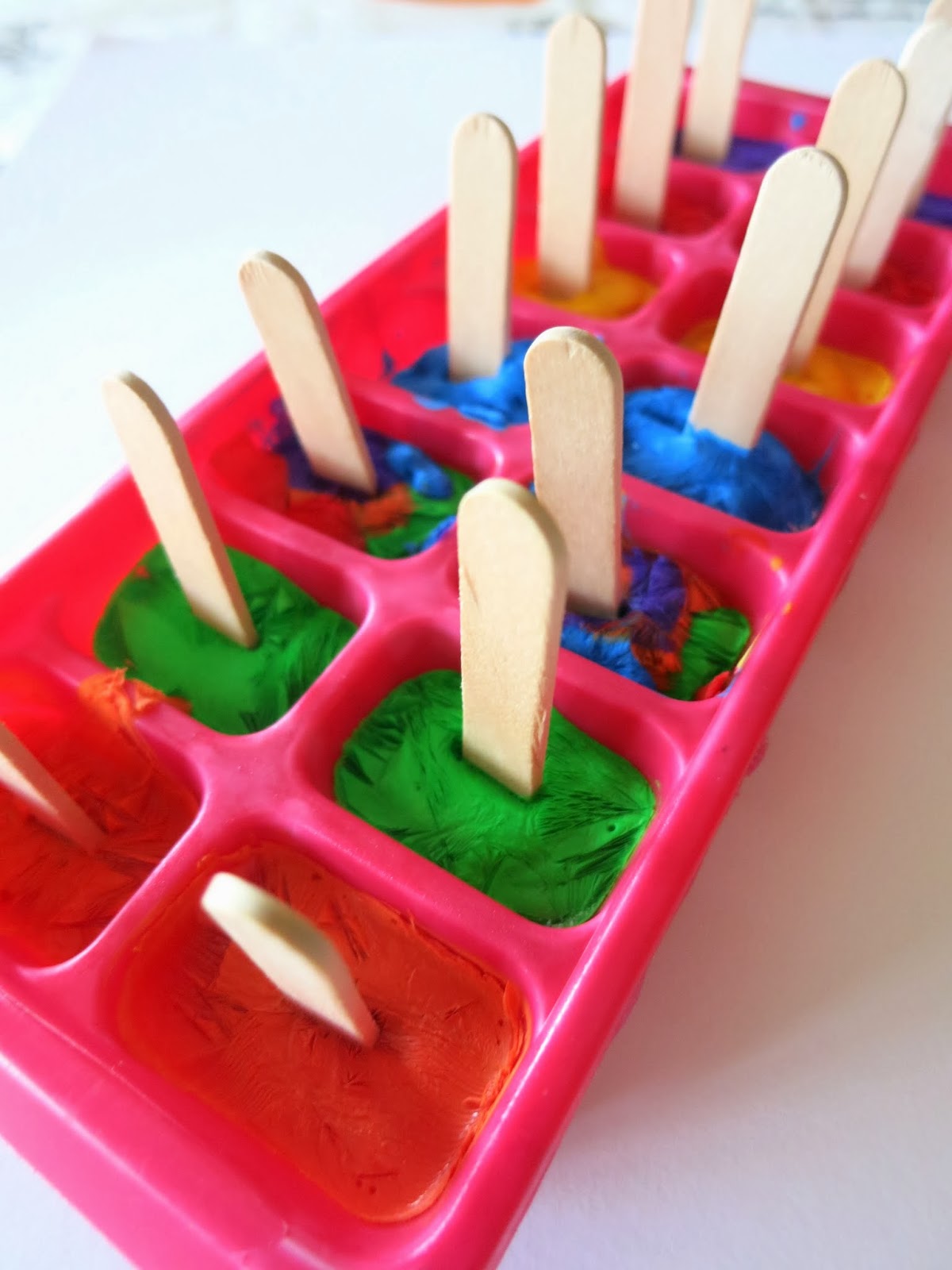 Learn with Play at Home Paintsicles. Frozen paint cubes for creative fun.