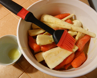 Parsnips and Carrots in Casserole Being Brushed with Butter