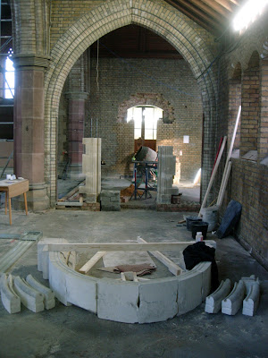 Stone arch reassembly, stone sections and hood moulding remaining