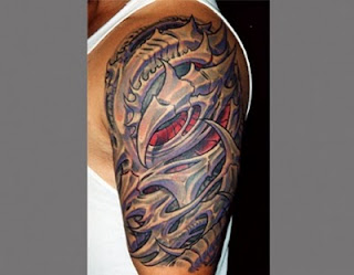 3d tattoo: alien-like bone structure tattooed on the shoulder