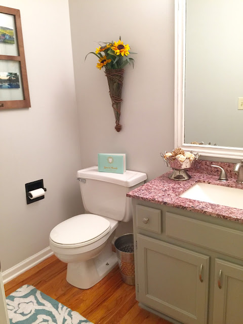 Valspar Tempered Gray: This true gray never changes its color, regardless of what kind of lighting the room has. It's a beautiful, airy color for living rooms, bedrooms, kitchens, bathrooms, and more. Click here to see how it was used in this half bath to take the space from gloomy to cheery. 