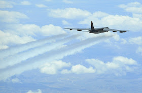 A B-52 Stratofortress flying with contrails.