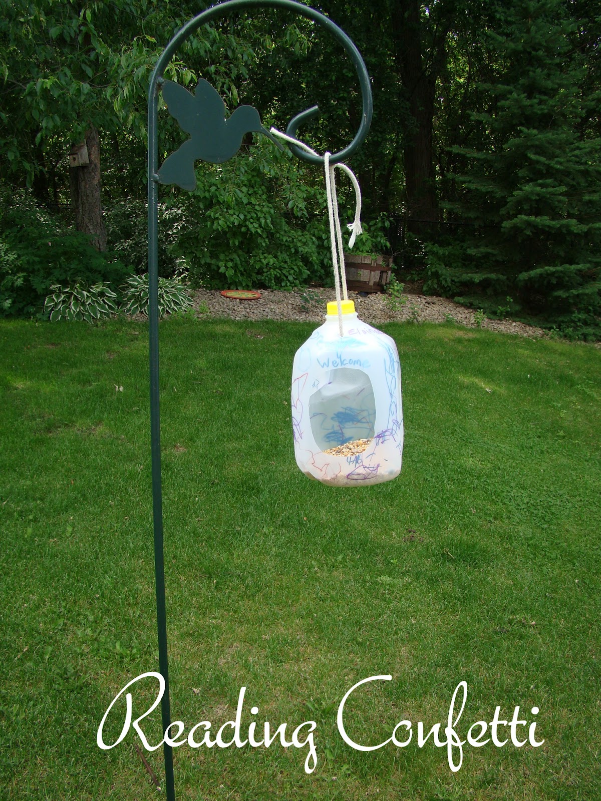 Bird Feeder from a Milk Jug Reading Confetti