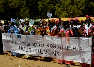 Holding a banner that reads,