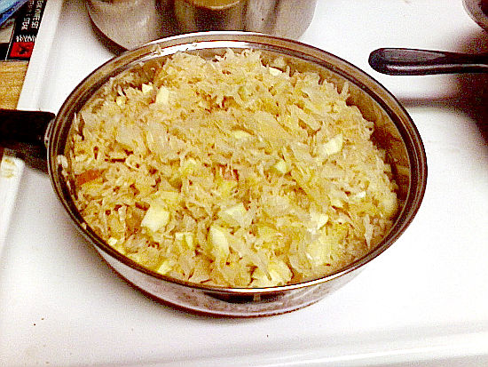 Pan on stove with German Sauerkraut and apple mixture.