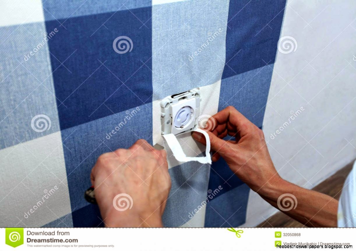 Decorator With Scalpel Hanging Wallpaper Over Wall Socket Royalty Decorator With Scalpel Hanging Wallpaper Over Wall Socket Royalty