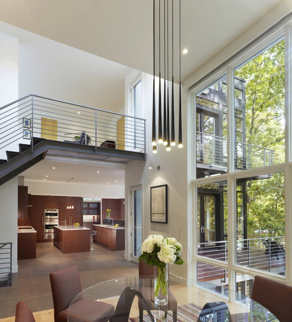 Dark Brown Soft Chairs and Circle Surface of Dining Table Made from Glass Panel