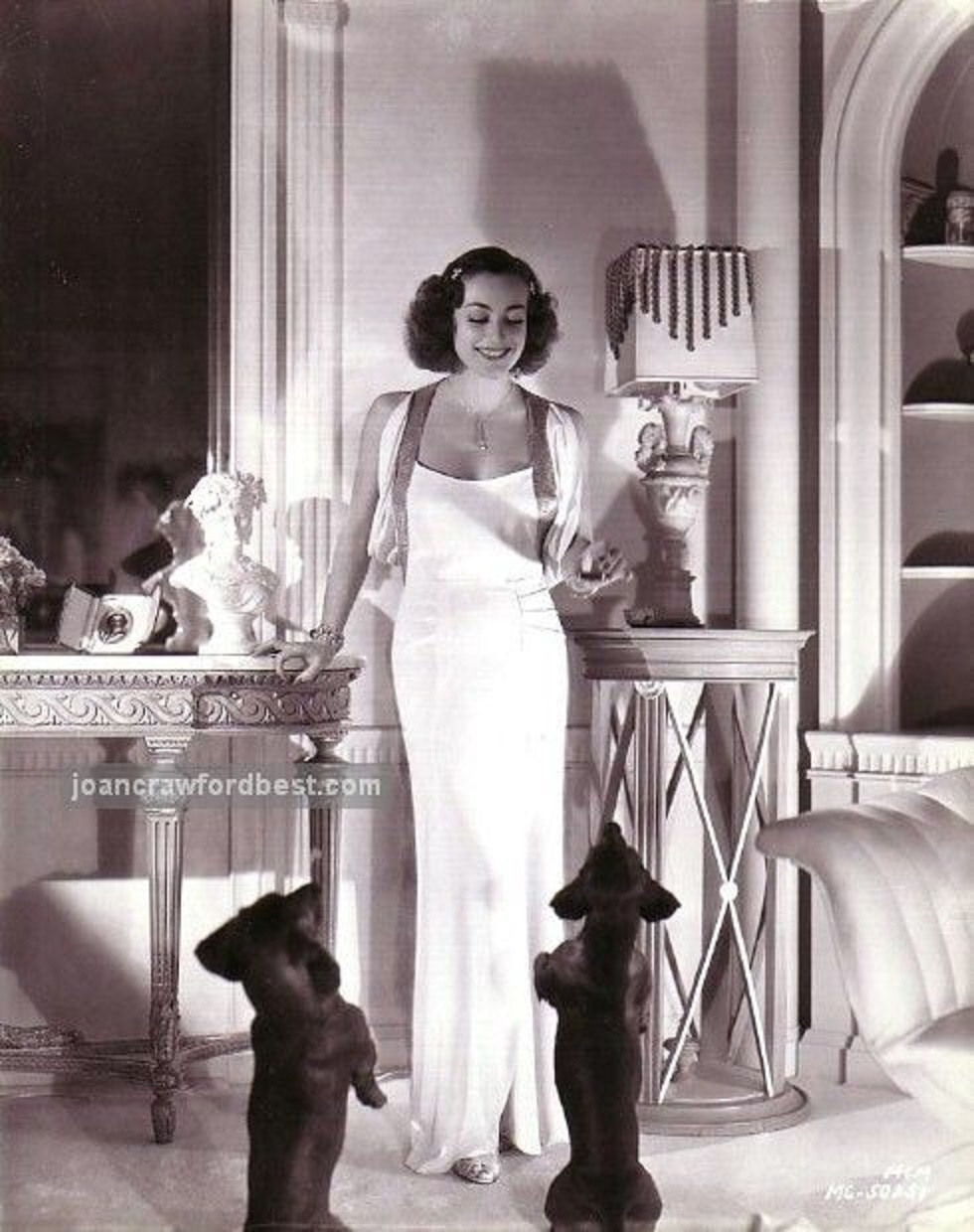 Joan Crawford and her Dachshunds, 1936, at home