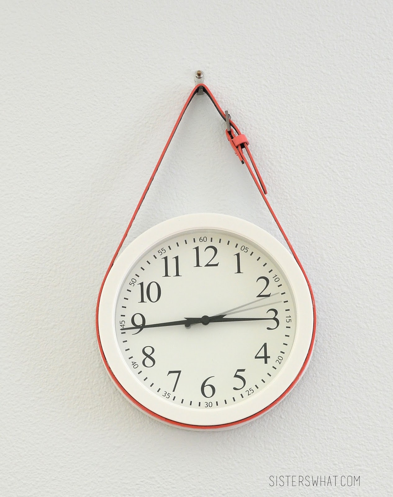 Add a colorful belt to a white, simple clock to add some color to a