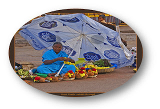 Women lady in India sitting on road under umbrella and selling Vegetables