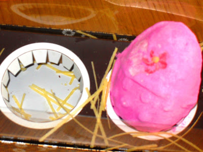 box empty of easter eggs, containing pink fluffy bath balistic from Lush
