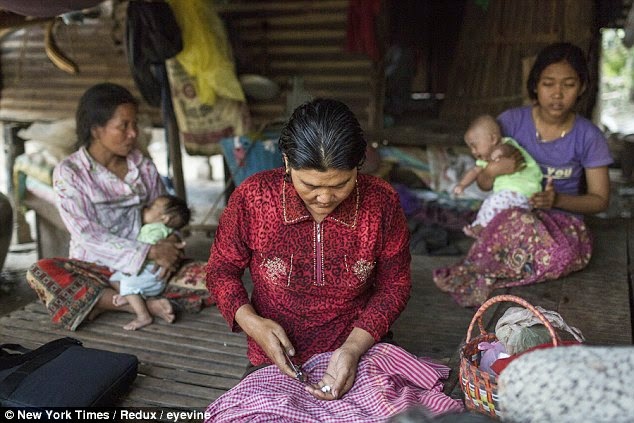 200 Villagers contract HIV after unlicensed doctor reuses syringes in Cambodia 1 Medic%2BYem%2BChrin%2Bhas%2Bbeen%2Barrested%2Bafter%2B200%2Bpeople%2Bwere%2Bdiagnosed%2Bwith%2BHIV%2Bin%2Bthe%2Bremote%2BCambodian%2Bvillage%2Bof%2BRoka%2B(pictured%2C%2BEm%2BMom%2C%2Bone%2Bof%2Bthose%2Binfected%2Bwith%2BHIV%2C%2Bprepares%2Bto%2Btake%2Bher%2Bmedication)