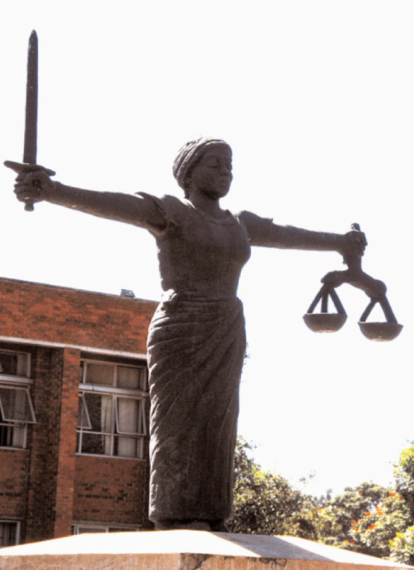 Zambian Crowd - LADY JUSTICE - DEPICTION Lady Justice, a blindfolded woman  carrying a sword and a set of scales, is a common symbol on courthouses.  She symbolizes fair and equal administration