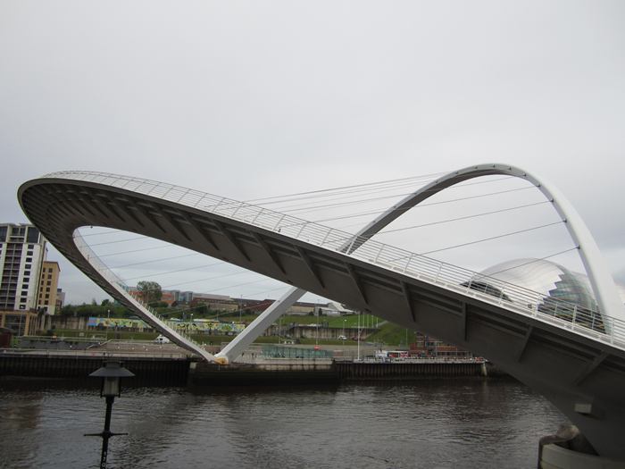 The Gateshead Millennium Bridge is a pedestrian and cyclist tilt bridge spanning the River Tyne in England between Gateshead's Quays arts quarter on the south bank, and the Quayside of Newcastle upon Tyne on the north bank. The award-winning structure was conceived and designed by architects Wilkinson Eyre and structural engineers Gifford. The bridge is sometimes referred to as the 'Blinking Eye Bridge' or the 'Winking Eye Bridge' due to its shape and its tilting method. In terms of height, the Gateshead Millennium Bridge is slightly shorter than the neighbouring Tyne Bridge, and stands as the sixteenth tallest structure in the city.