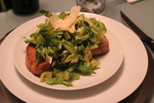 Shredded caesar salad on toast