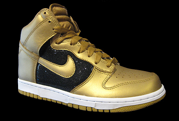 feet was a pair of high top Nike sneakers. Black and gold nike sneakers