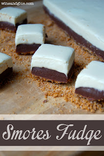S'mores Fudge with a graham cracker crust and delicious marshmallow fudge topping sandwiching delicious chocolate fudge! via www.wineandglue.com