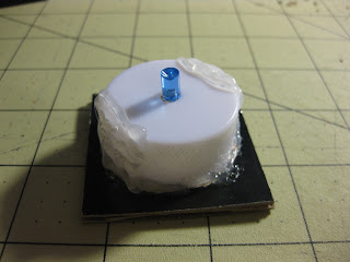 Adding the LED tea light to base with hot glue. 