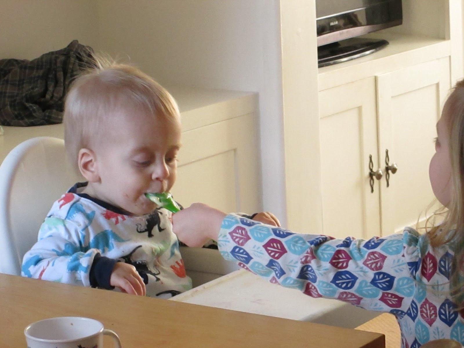 Lily feeding her little brother