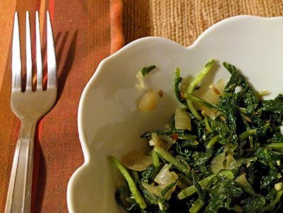 Bowl of Spicy Greens with Cumin at Place Setting
