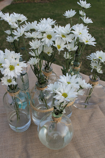 daisies in glass vases