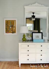 White dresser and mirror. Blue and green master bedroom.