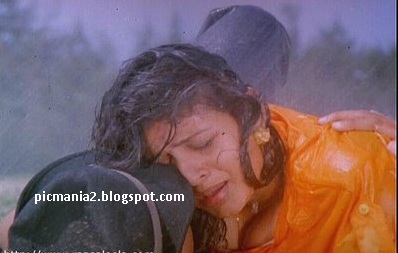 Suchitra boobs popping out rare cleavage show in wet image gallery