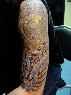 biomech tattoo: alien-like tissues tattooed on the upper arm