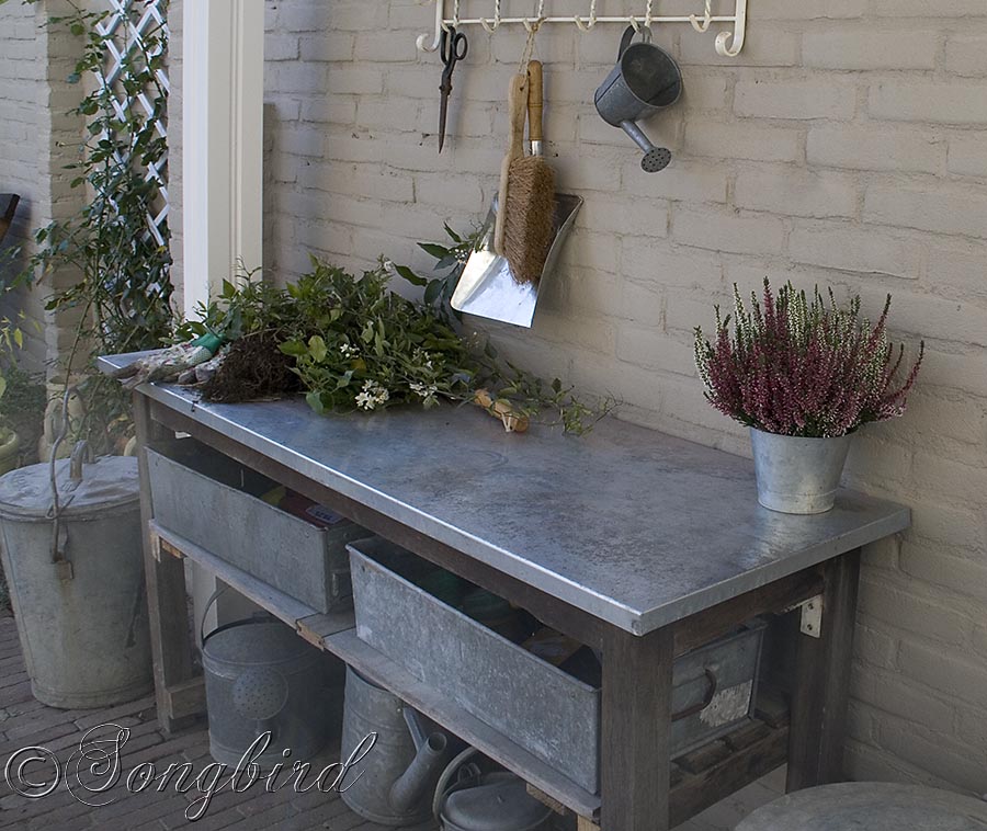 Vintage coat rack finishes a garden work area with a work bench with