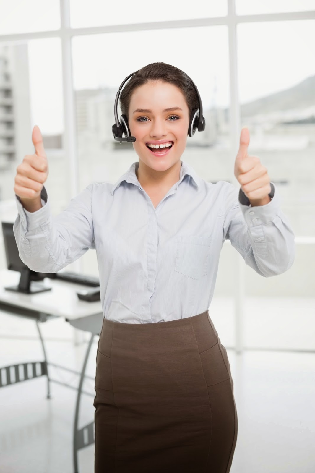Millennial woman wearing headset and giving thumbs up