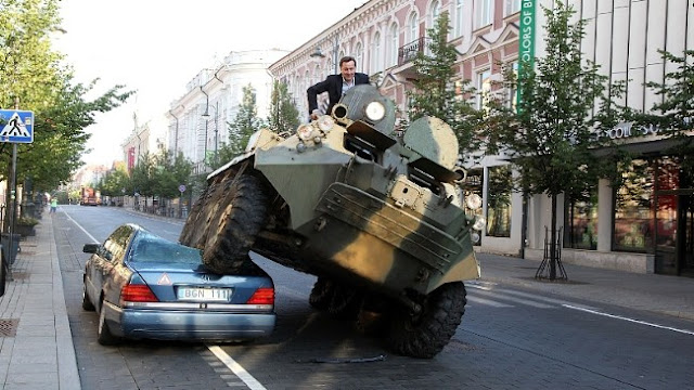 Mayor Arturas Zuokas of Vilnius drives over Merceds with a tank against illegal parking