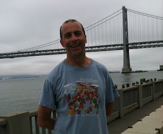 a man standing in front of a bridge