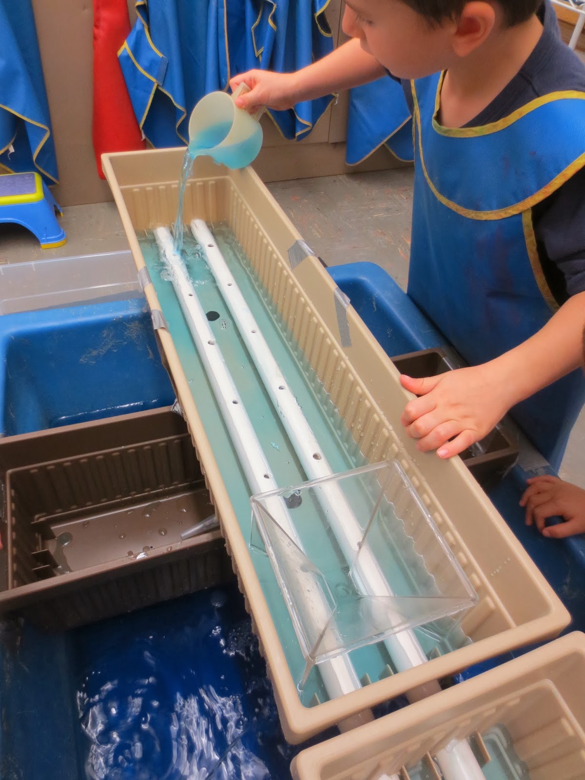 SAND AND WATER TABLES PIPES EMBEDDED IN PLANTER TRAYS