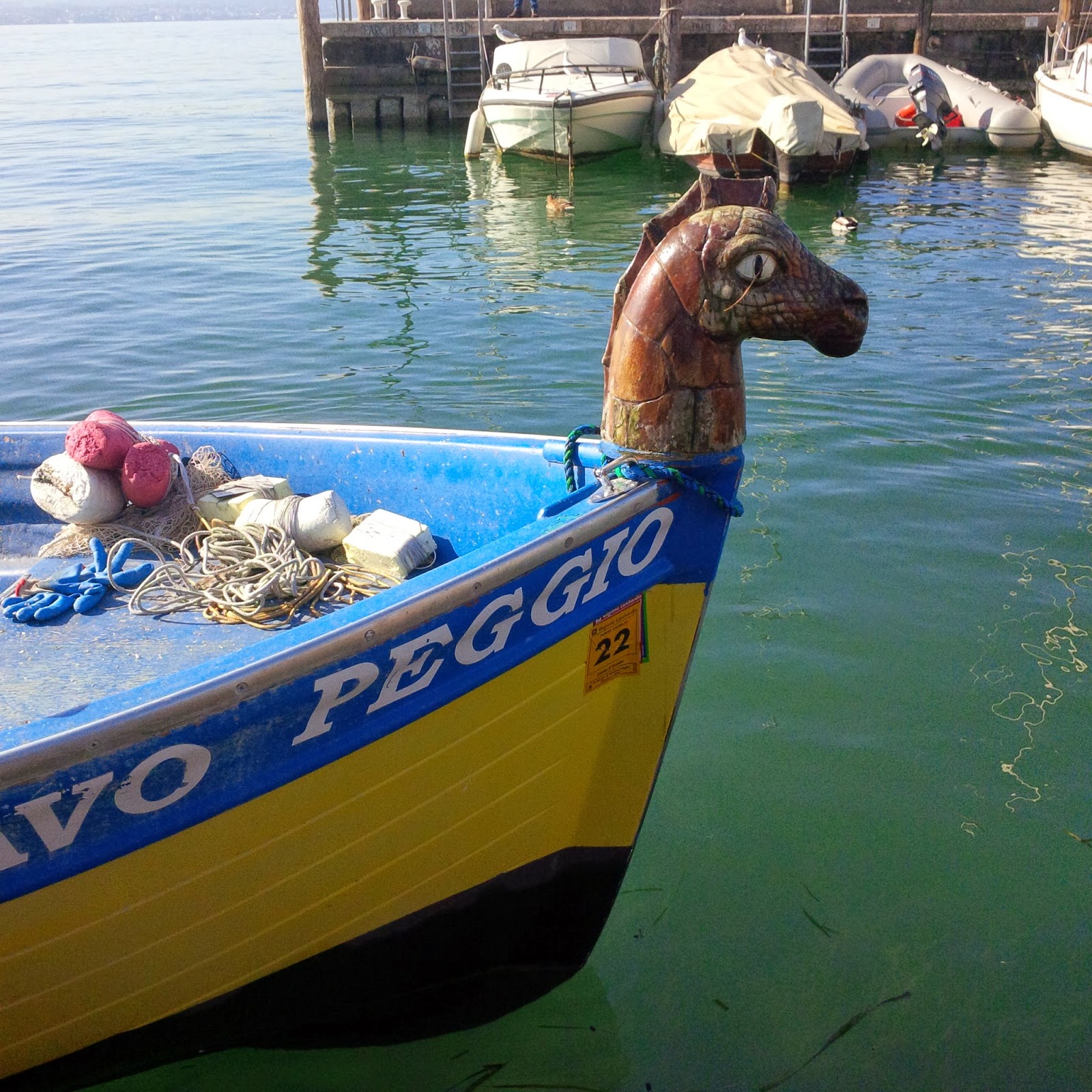 A seahorse figurehead on a boat in Sirmione's harbour