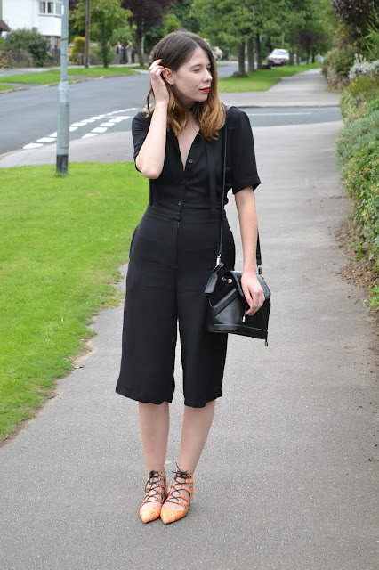Womens affordable highstreet fashion blog featuring British street style. Topshop Black button down playsuit with cut out back. orange snake skin lace mid heel shoes from ASOS. Black suede and leather and Topshop