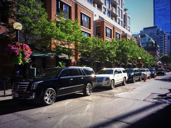 Our fleet of 2015 Cadillac Escalade's outside the hotel
