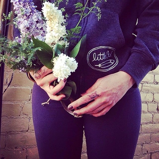@larch_and_lager in her little owl "three sisters" hoodie holding a beautiful bouquet. Via instagram.