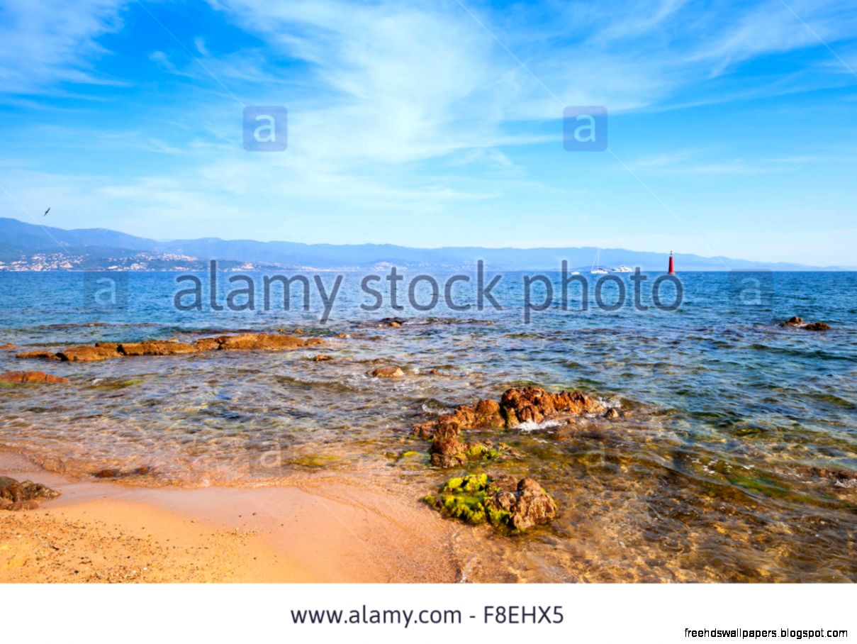 Red Coastal Stones On Public Beach Of Ajaccio Corsica Island Red Coastal Stones On Public Beach Of Ajaccio Corsica Island