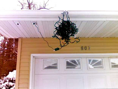 simple lights, Christmas lights in a tangled mess hanging off the gutter over the garage portraying a humorous image of low maintenance christmas decorating